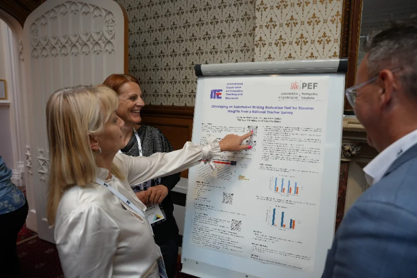 A presenter discussing her research poster with conference participants