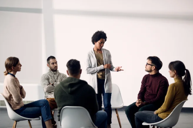 A researcher presenting to colleagues around a table